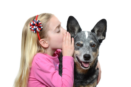 little girl whispering to her dog
